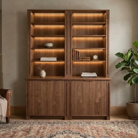 A walnut modular DIY bookcase with integrated lighting and lower cabinets styled in a warm living room. Plans de bibliothèque haut de gamme. Plans de bibliothèque haut de gamme.